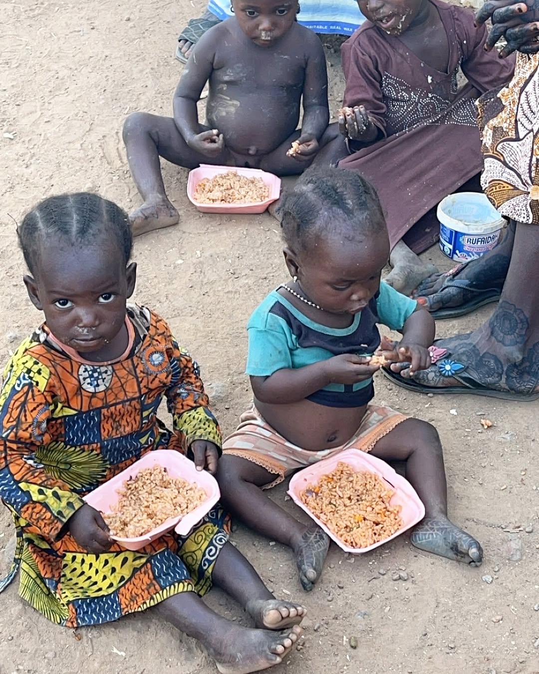 Kids eating rice
